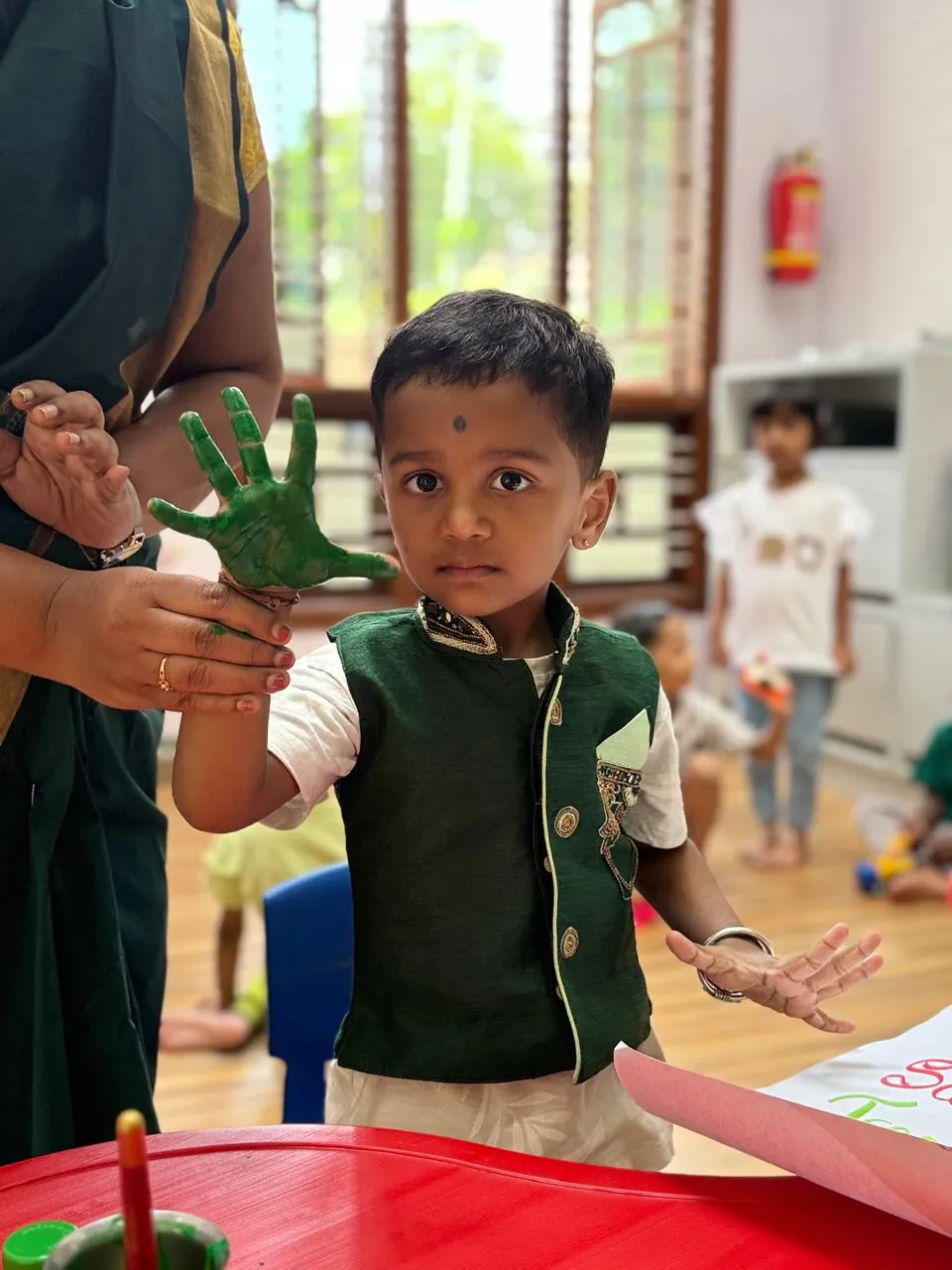 Child enjoying hand painting at FlyHigh Pre School