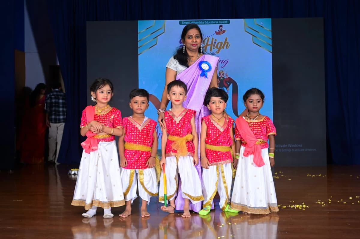 Children in traditional attire on stage at FlyHigh