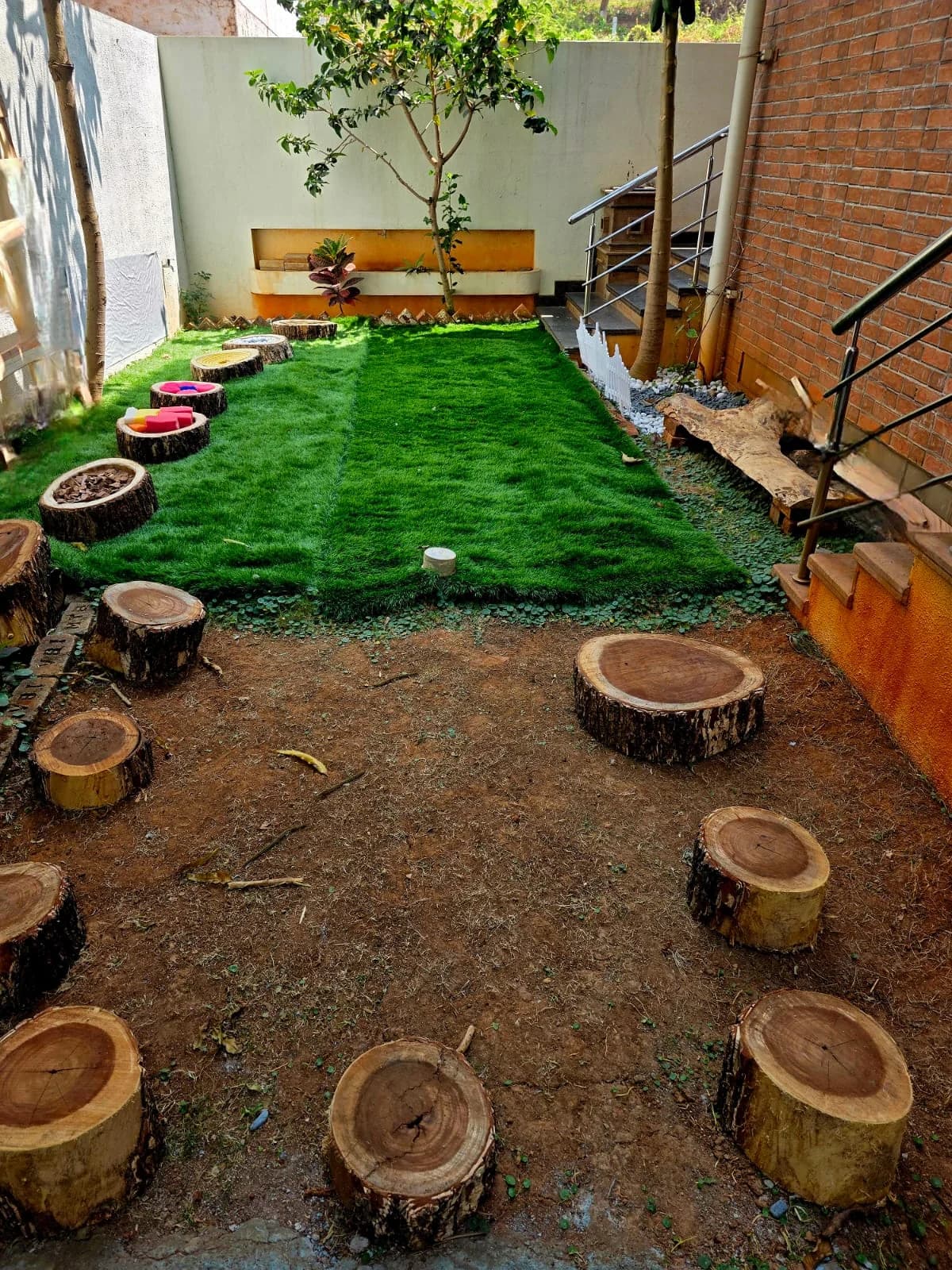 Outdoor garden with log seating at FlyHigh